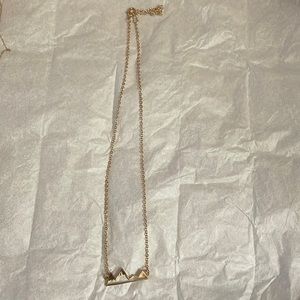 Gold necklace with mountain detail.